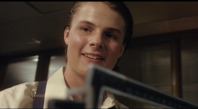 To provide for his family after his father's murder, a 15-year-old boy must lie about his age in order to enlist in the Navy during WWII. Based on a true story.